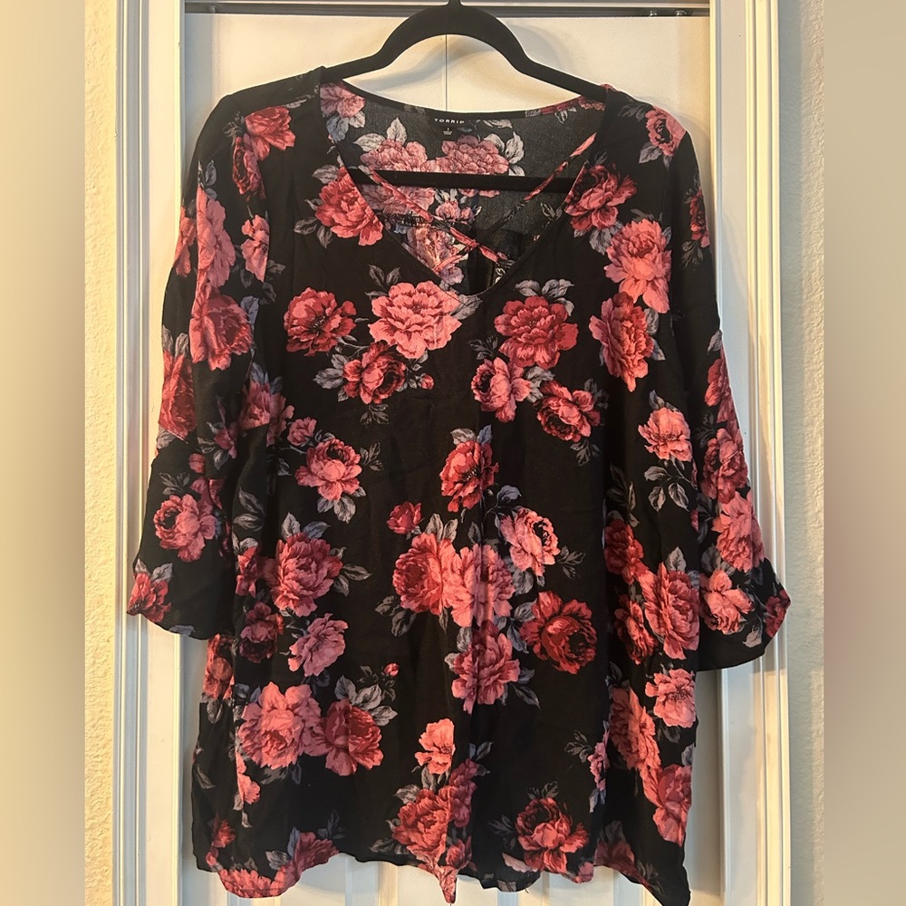 Torrid pink flowered cross front blouse.